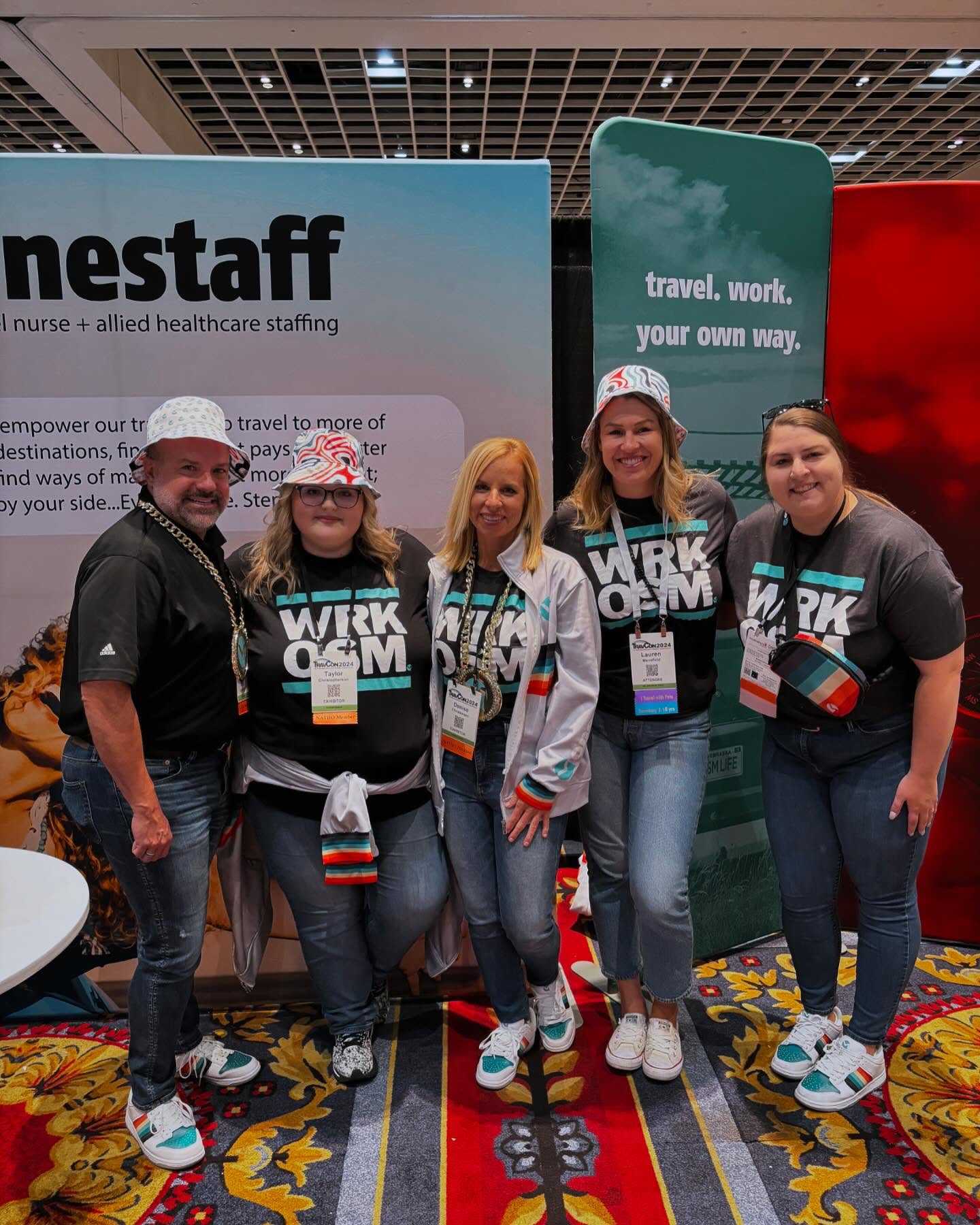 Five-person OneStaff team in the full retro hip hop kit in front of the brand banner