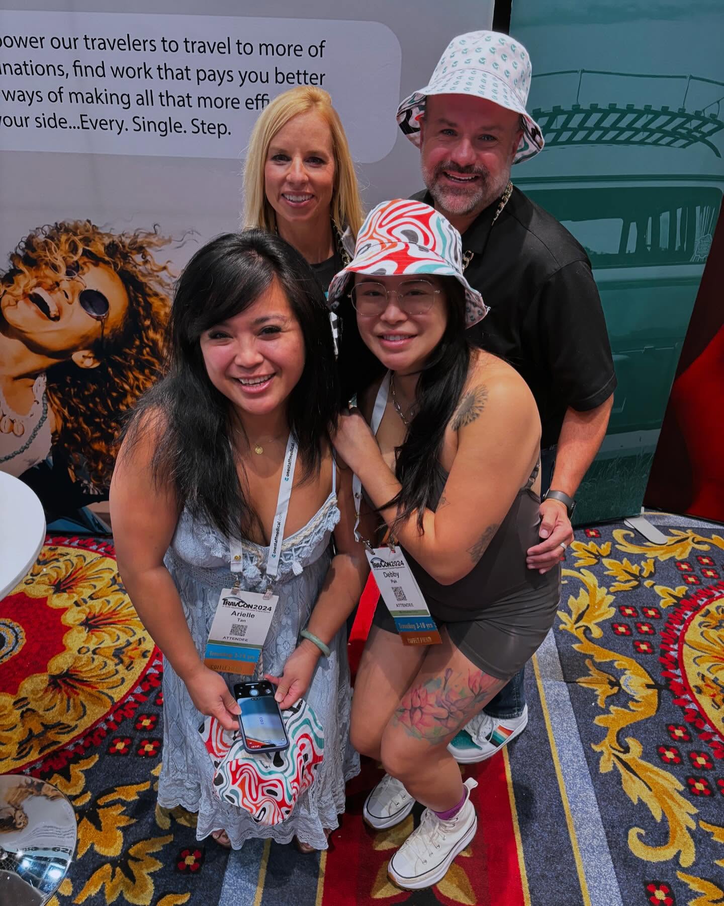 TravCon attendees wearing the OneStaff bucket caps at the booth — fans rocking the merch