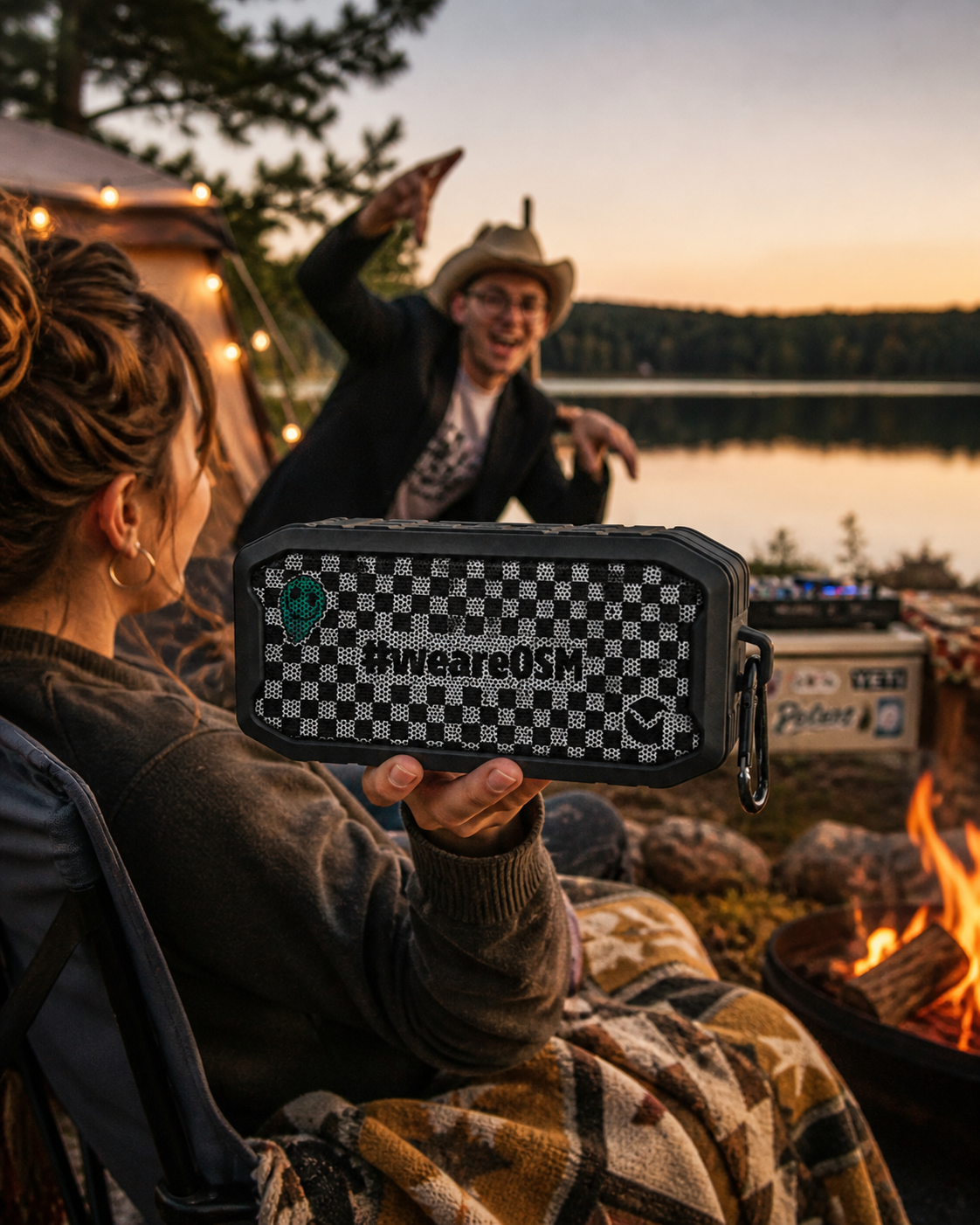 OneStaff #weareOSM speaker held up at a lakeside campfire
