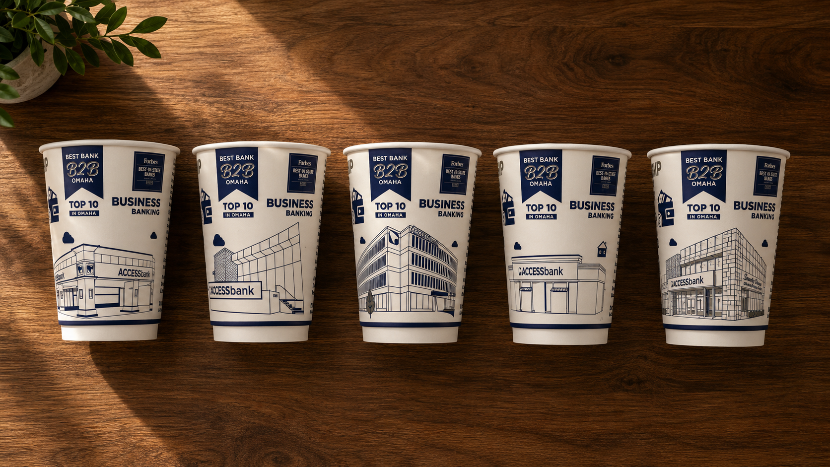 Five ACCESSbank branch coffee cups — each with a custom line illustration of its building