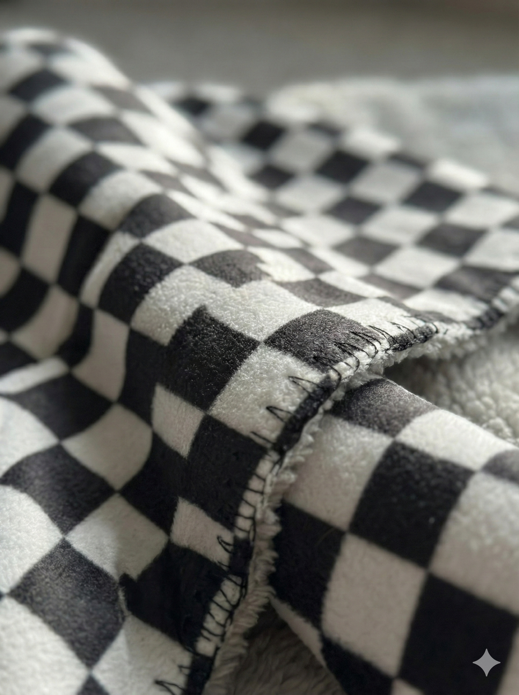 Macro detail of the OneStaff black and white checkered scarf weave